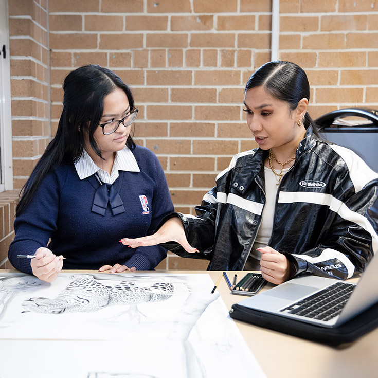 Art teacher assisting student at Emmaus Catholic College Kemps Creek